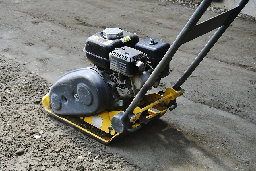 A Close Up Image Of A Vibrating Soil Compactor Used To Compact S